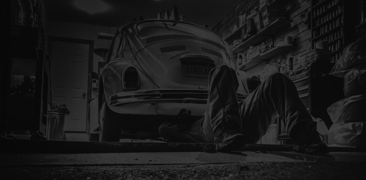 Background image of a mechanic fixing a car.