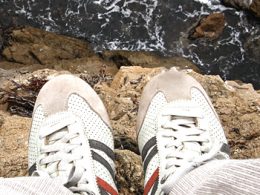 Looking down upon shoes over a cliff